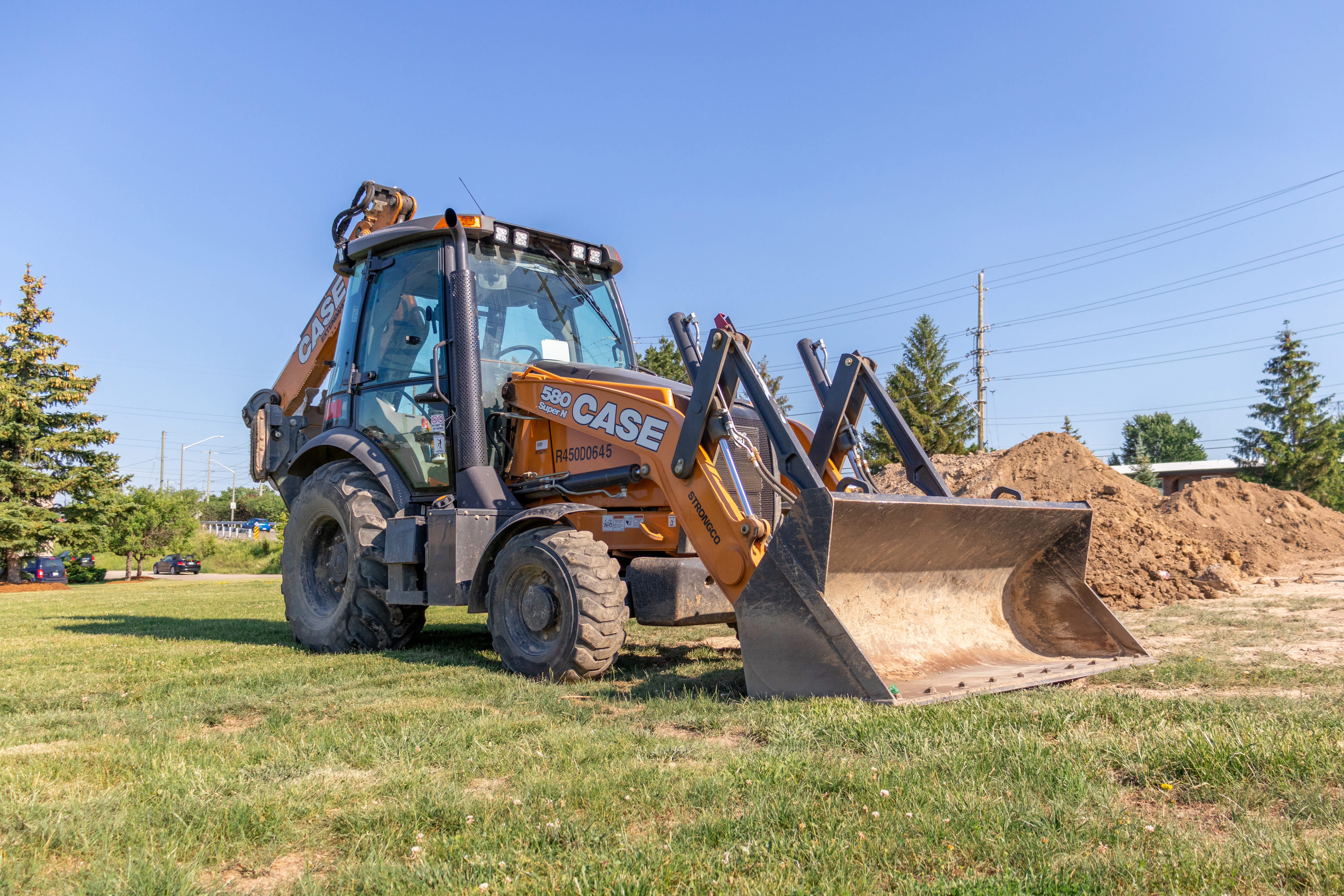 Backhoe loader rental parked on construction site